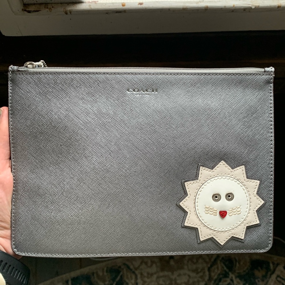 Coach pouch with lion decal